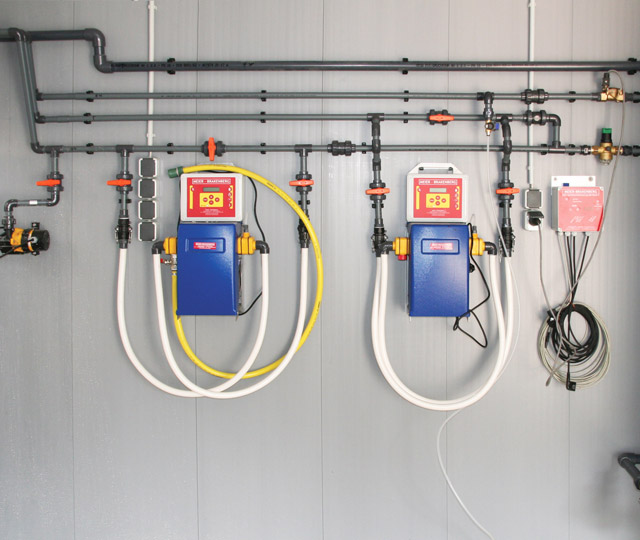 Water distribution inside pigsty with two permanently integrated electrical medication dosing systems - both with MBDos1. This arrangement facilitates parallel dosing of acids and medication into the drinking wate